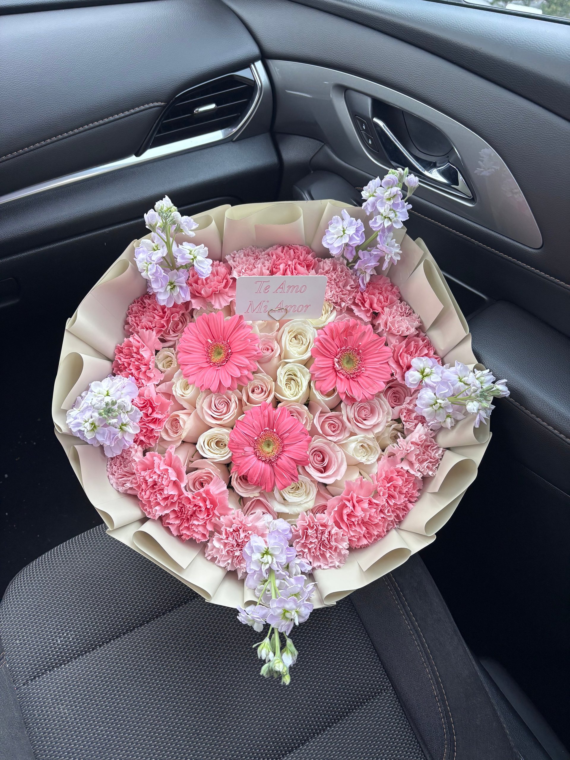Large bouquet of pink roses, gerbera daisies, and purple carnations