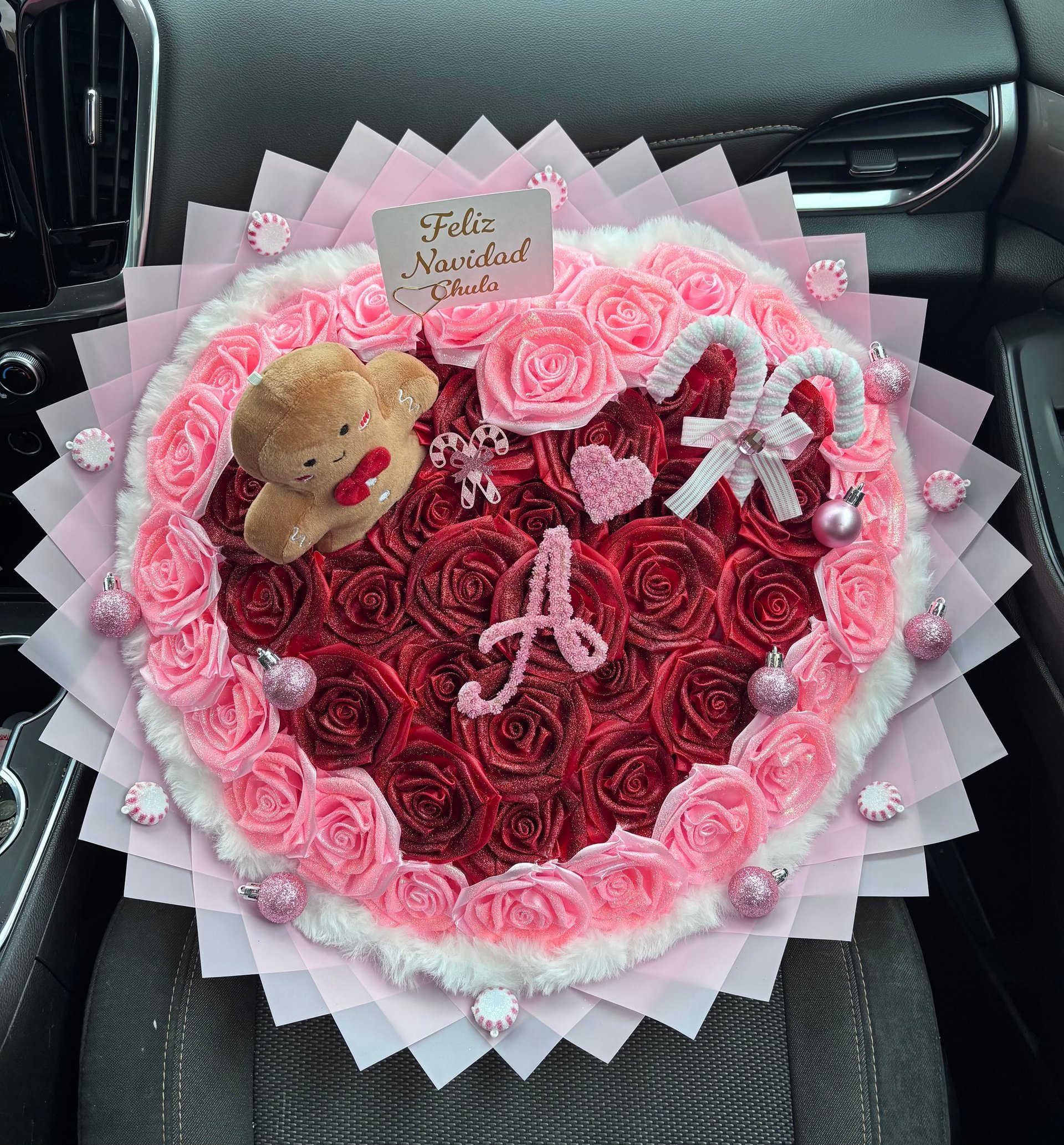 Heart-shaped floral arrangement with teddy bear and Feliz Navidad