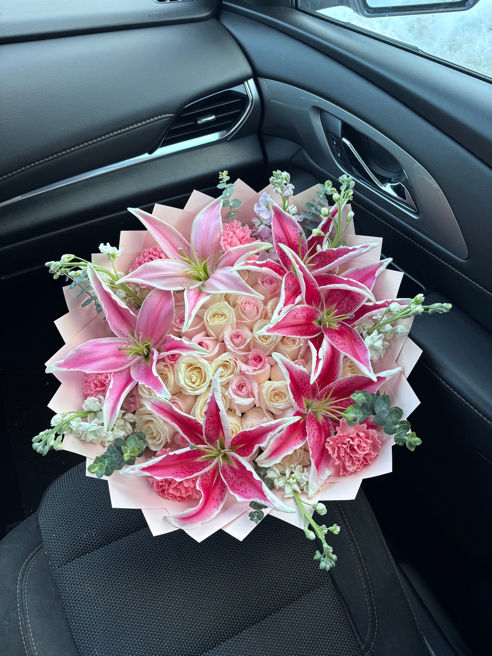 Luxurious bouquet of pink lilies, roses, and carnations
