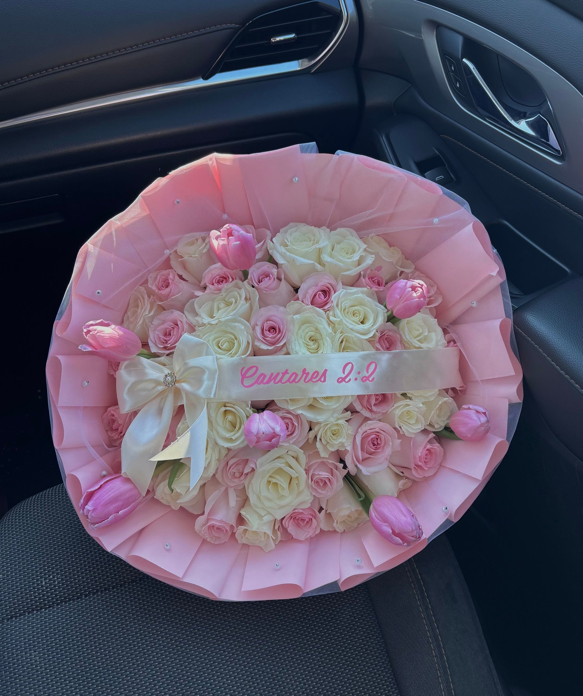 Luxurious bouquet of pink and white roses with white bow